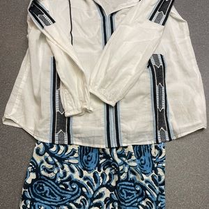 Michael Kors embroidered white voile top with elastic cuff, blue design. Size M